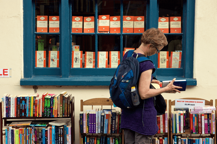 A walker browses books in Hay-on-Wye on Offa's Dyke Path